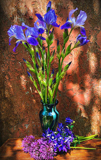 Romantic bouquets of flowers. Home decor and flowers arranging. In composition used blue irises and purple aliums