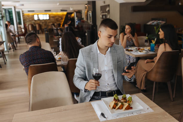 istock Handsome young businessman having lunch in restaurant 1400790818