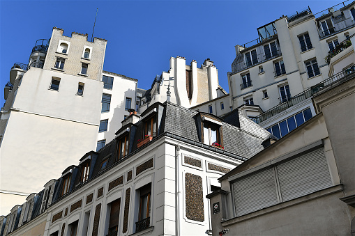 Paris, Octobre 2023 : Visit of the magnificent city of Paris, Capital of France - View on different facades of buildings built by Baron Haussmann