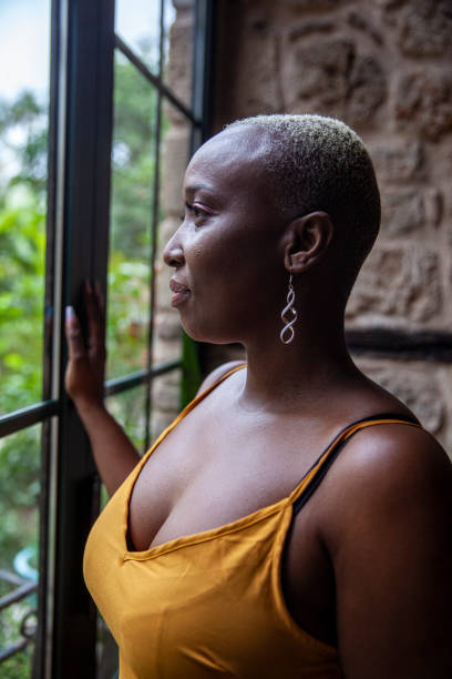 istock Beautiful woman looking out the window 1400793554
