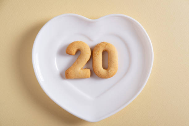 istock Biscuits forming number 20 on the white plate and yellow light background 1400794171