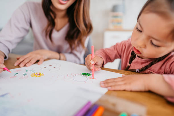 istock Mother Drawing With Her Child 1400795596