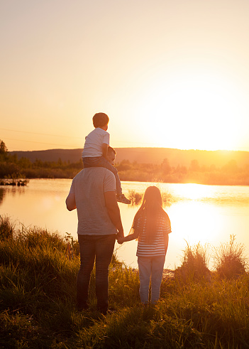silhouette of a family on the background of a sunset outdoors close-up