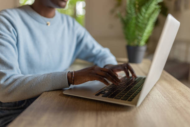 istock Unrecognizable female student Black ethnicity using laptop, while studying from her college dorm 1400797086