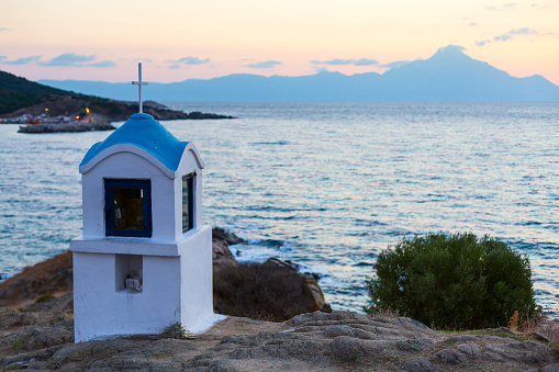 Small greek chapel and mount Athos with sea panorama in Greece