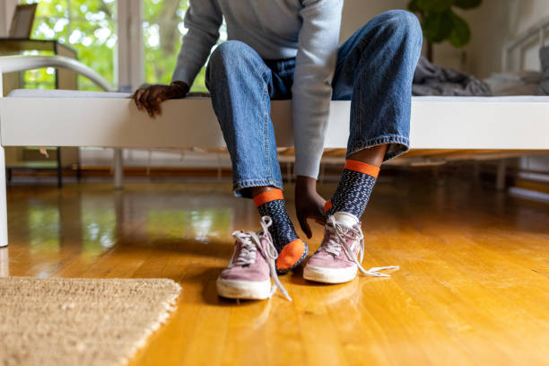 istock Unrecognizable woman Black ethnicity put her shoes on 1400799302
