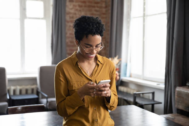 istock Happy cellphone user woman in glasses reading online chat 1400800105