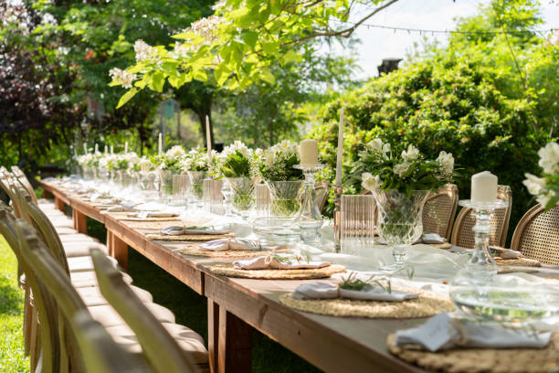 Wedding guest setup with fresh flowers Wedding guest setup with fresh flowers in back yard garden lights candle stock pictures, royalty-free photos & images