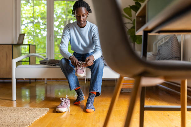 istock Woman Black ethnicity put her shoes on 1400801239