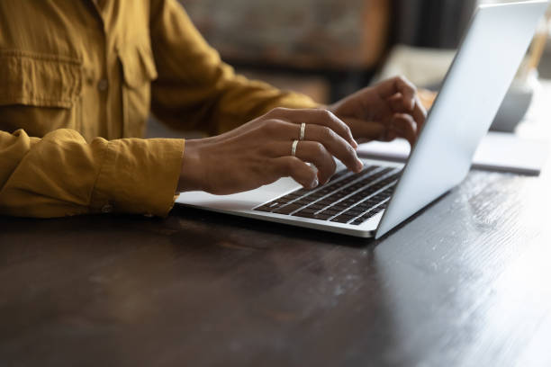 istock African female employee working at laptop, typing on keyboard 1400801426
