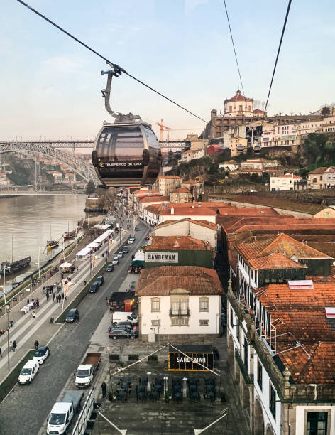 New village of Gaia, Porto, Portugal. View from Teleferico de Gaia cabin, a cable car Aerial view of Dom Luis I Bridge on Douro River, Monastery of Serra do Pilar and roofs of cellars from Teleferico de Gaia, a cable car in Vila Nova de Gaia. vila nova de gaia stock pictures, royalty-free photos & images