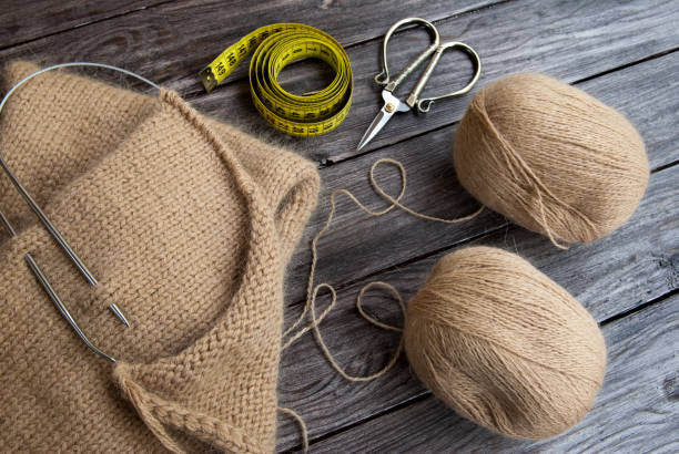 istock Knitting scarf from beige wool yarn 1400805475