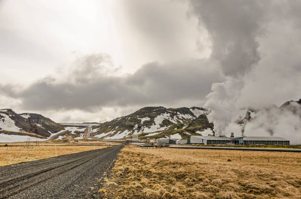 Hengill, Iceland, April 22, 2022: road towards the  Hellisheiði geothermal power plant, recognizable by the clouds of steam