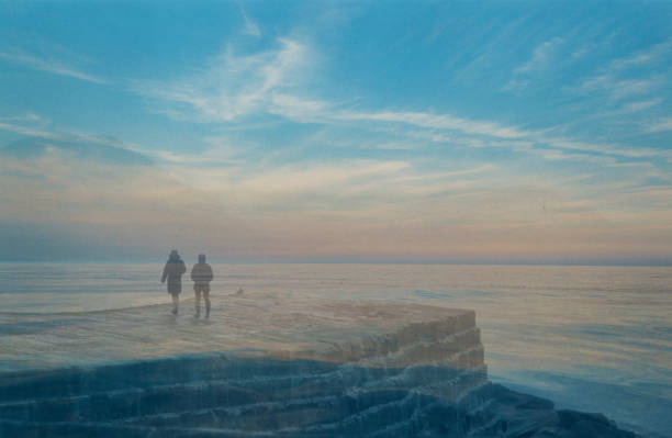minimal surreal landscape, man walking on the beach beside the calm sea