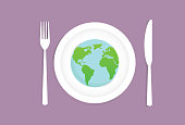 istock A globe on a dish with fork and a knife 1400808893