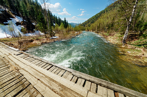 Bridge over the river in a tourist place in the mountains of Siberia.