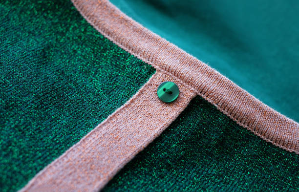 istock Green and pink knitted jumper with one button. Close-up image 1400811012