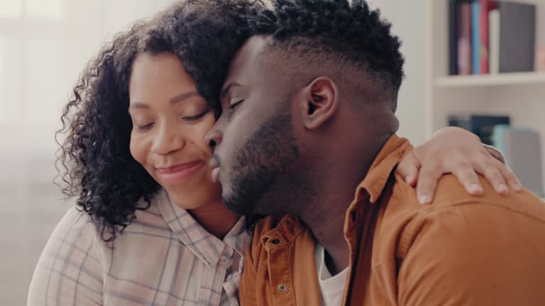 Beautiful African American woman trying to reconcile with offended husband