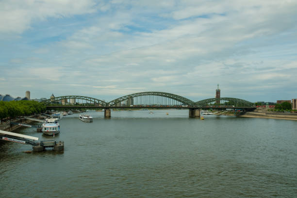 Cologne, Germany - May 17, 2022 : View of the river Rhine and  the famous Hohenzollern bridge that is used only by trains and pedestrians