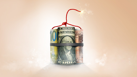 Rollos de dinero global mundial que simbolizan dinamita con fusible encendido photo