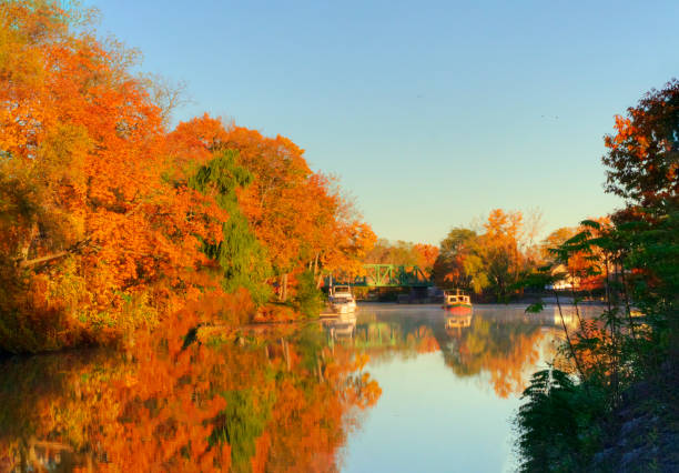 Erie Canal with long boat in fall-Pittsford,New York Erie Canal with long boat in fall-Pittsford,New York erie canal stock pictures, royalty-free photos & images