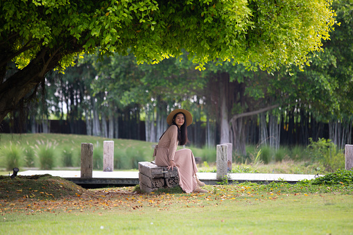 woman sitting under a tree