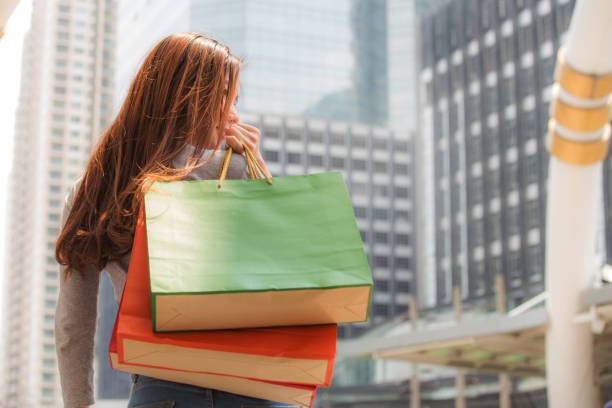 Girl holding shopping paper bags in the city