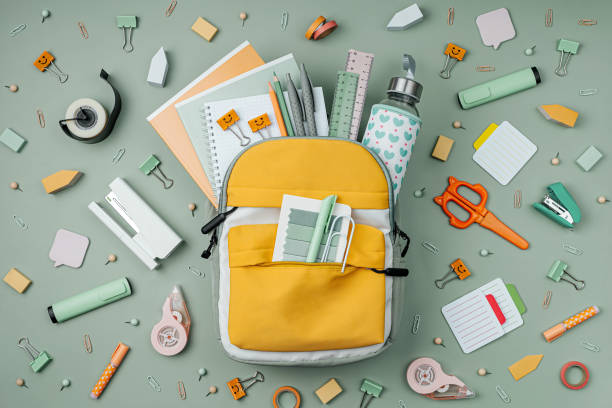 Opened School backpack with stationery  on green background. Concept back to school. School supplies. Opened School backpack with stationery  on green background. Concept back to school. School supplies. office supply stock pictures, royalty-free photos & images