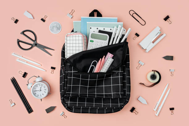 istock Opened School backpack with stationery  on pink background. Concept back to school. School supplies. 1400820383