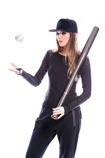 Baseball pitcher, ball sports and a athlete woman ready to throw and pitch during a competitive game or match on a court. Fitness, workout and exercise with a female player training outside on field