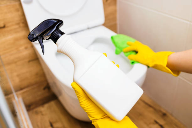 istock Close-up of gloved hands using toilet bowl sanitizer solution, bottle mockup 1400827136