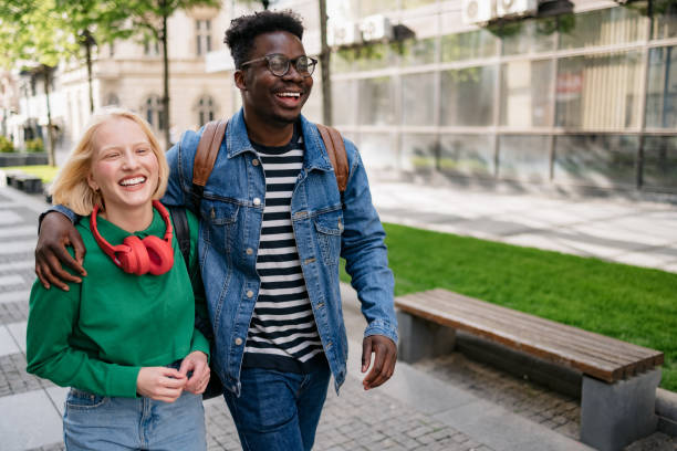 istock Happy diverse couple walking around the city 1400830138