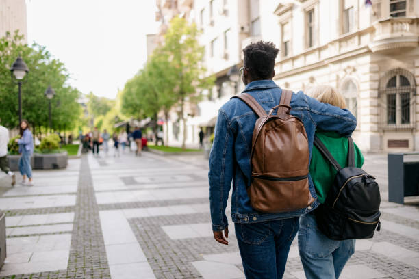 istock Diverse couple walking through the city 1400830141