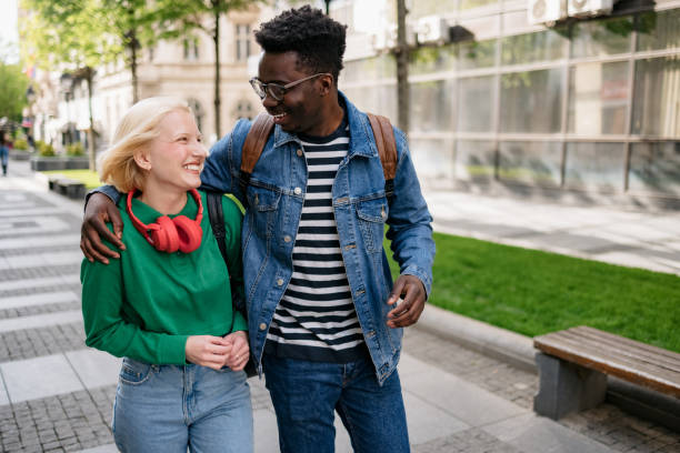 istock Happy diverse couple walking around the city 1400830171