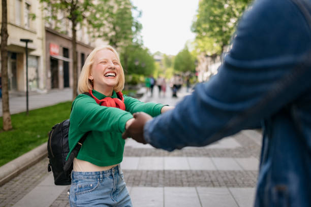 istock Happy diverse couple bonding while walking through the city 1400830255
