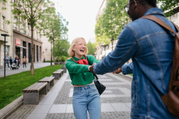 istock Happy diverse couple bonding while walking through the city 1400830264