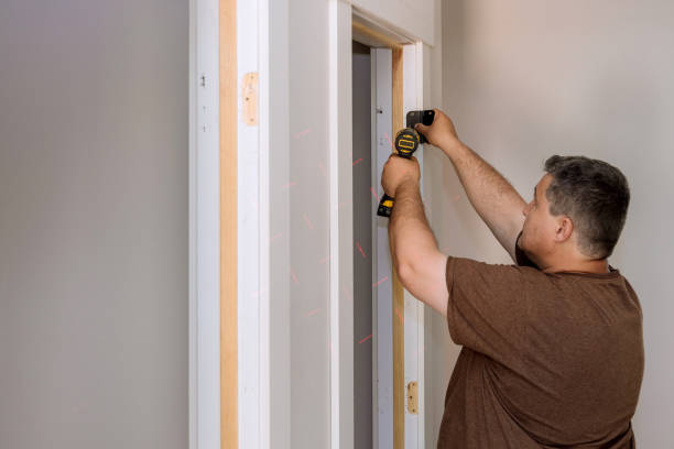 istock Installing the door hinge on the door frame using a screwdriver a home reconstruction 1400831462