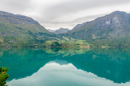 Reflection in Norway fjord at fall time