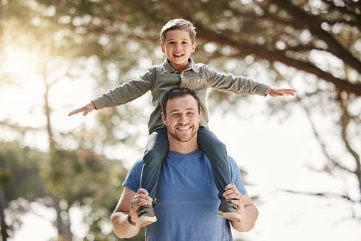 Photo of young father taking his two sons outdoors, in the nature, for some outdoors activities and bonding with nature