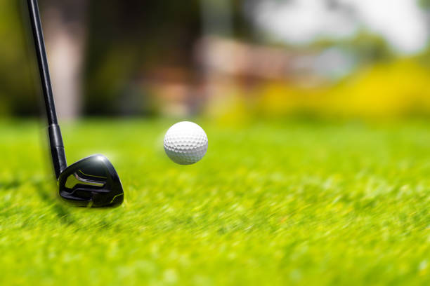 Golf ball on the edge of hole.