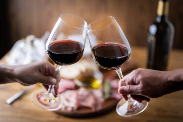 istock toasting with red wine with italian antipasto plate 1400835832