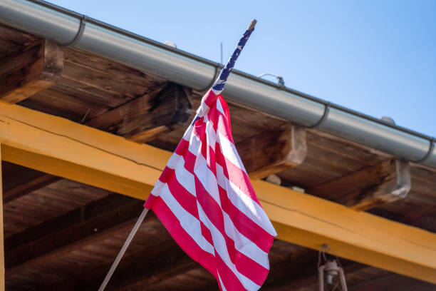 istock flag flies against a blue white sky 1400836019