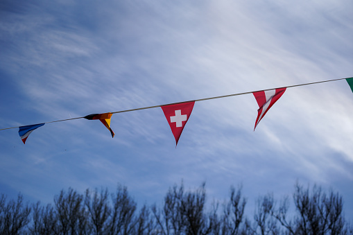 flag flies against a blue white sky on a summer day in Bavaria