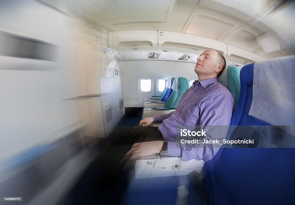 Businessman resting on a airplane Man resting on a plane Adult Stock Photo