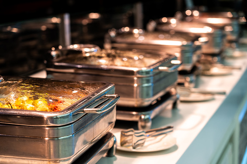 Catering buffet food with heated trays ready for service