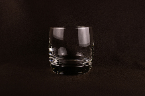 Glass Cup on a dark brown background