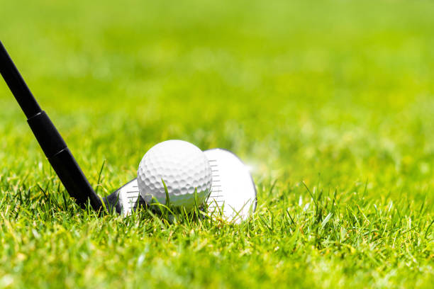 istock Golf iron club ready to hit a ball on green grass on golf course 1400843669