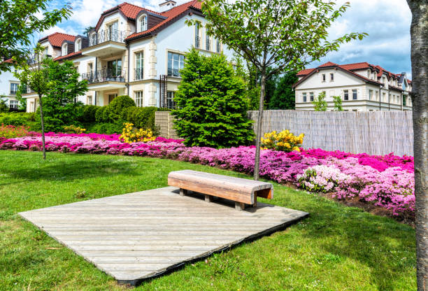 istock Wooden garden bench in fresh green spring park 1400844848