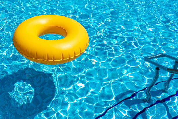 istock Yellow ring floating in refreshing blue swimming pool 1400844906