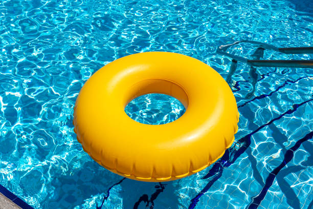 istock Yellow ring floating in blue swimming pool. Inflatable ring, rest concept 1400846468